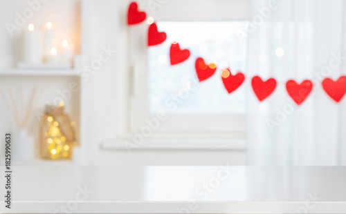 Holiday mock up for design and product display with empty white table on decorated with red hearts blurred window interior background