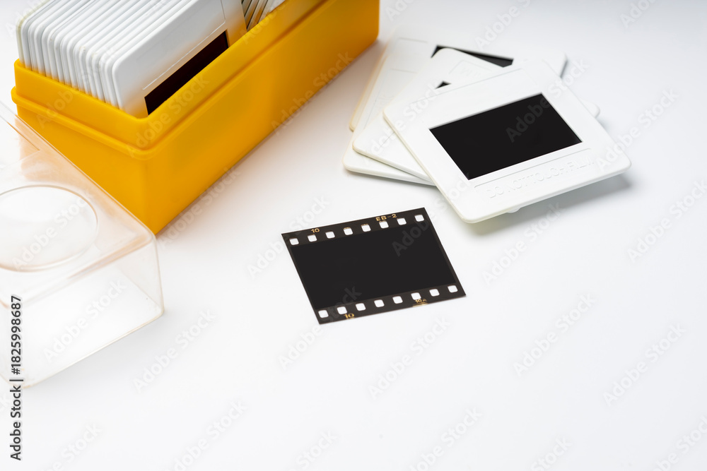 Fototapeta premium Close up of 35mm slide film and box on white background , Analog vintage records of memories in 1970s