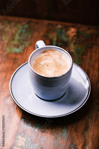 Cup of coffee on rustic wooden background. Soft focus. Copy space	