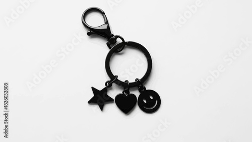 Stylish black charm keychain featuring a star, heart, and smiley face, perfect for adding a touch of personality to your keys or bag