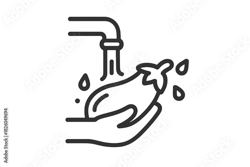 Hand washing fresh eggplant under running water from a kitchen faucet for food preparation and hygiene
