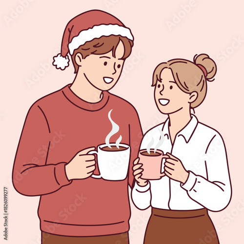 Young man and woman wearing festive red hats enjoy hot coffee or tea together. Couple having a conversation and warming up with hot drinks during winter holidays.