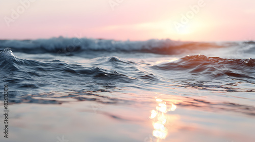 Sunrise Serenity: Capturing the tranquil beauty of the ocean at dawn, with gentle waves illuminated by the soft glow of the sun, invoking a sense of calm and peace.