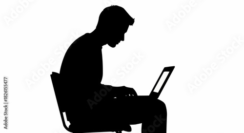 Silhouette of a person working diligently on a laptop computer.