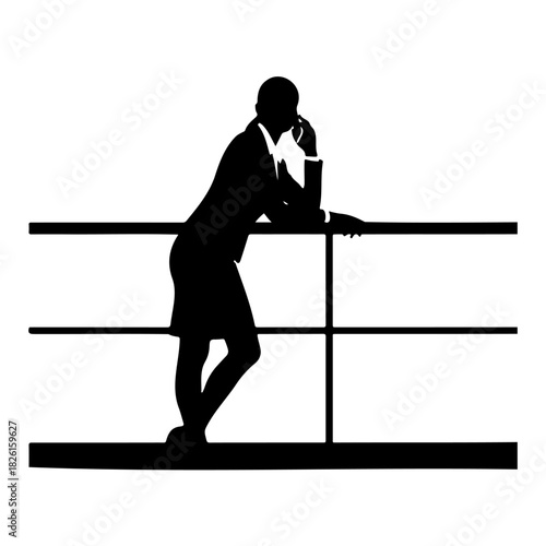 Silhouette of businesswoman leaning on railing while using her phone