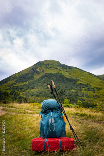 Summer hiking in the mountains with a backpack and a tent. Beautiful mountain landscape.