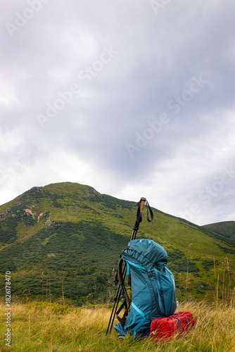 Summer hiking in the mountains with a backpack and a tent. Beautiful mountain landscape.
