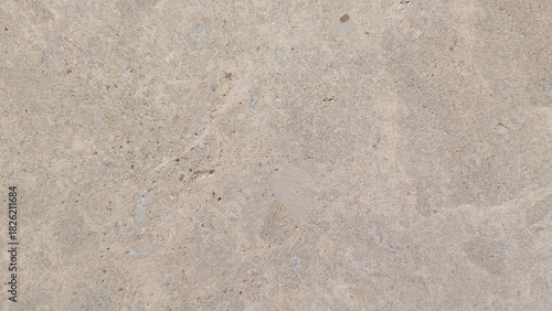 Close-up of a textured concrete surface with natural imperfections and subtle variations in tone.
