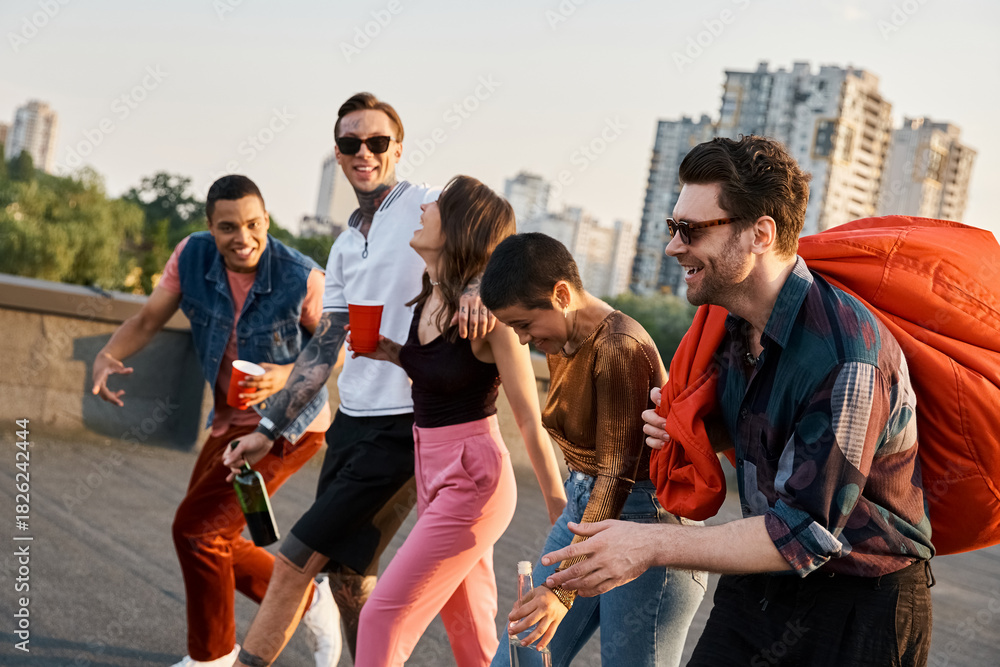 Fototapeta premium Young friends celebrating joyfully on a rooftop party in the city at sunset