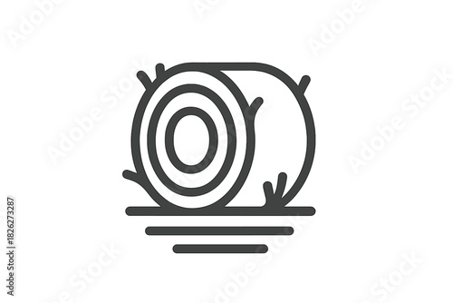 Large rolled hay bale resting on the ground in a field during the agricultural harvest season