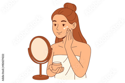 Young woman applying moisturizing cream to her face while looking in a small vanity mirror