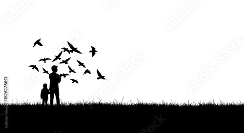Silhouette of father and child feeding birds in a grassy field