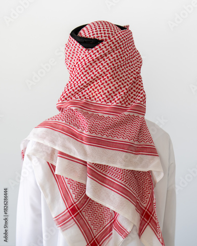 Close up portrait of man wearing traditional arabic clothing, standing against white background. High quality photo