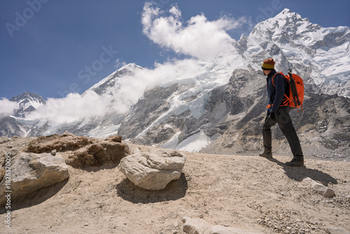 Hiker admiring Mount Nuptse peak on Everest Base Camp trek, Nepal