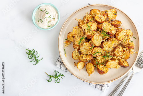 Crunchy Oven-Baked Potato Wedges With Condiment Garnished With Fresh Rosemary