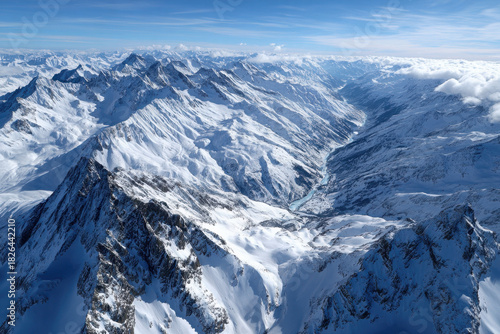 Aerial view of snow capped mountains and valley
