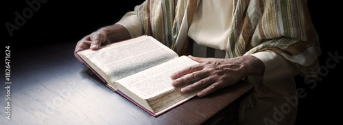 Old man reading a big book