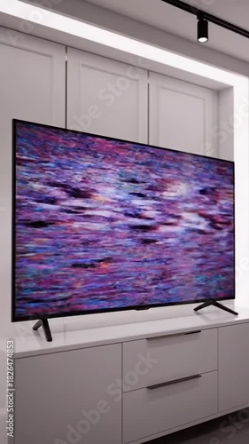 A modern TV displays an abstract, colorful pattern in a minimalist living room
