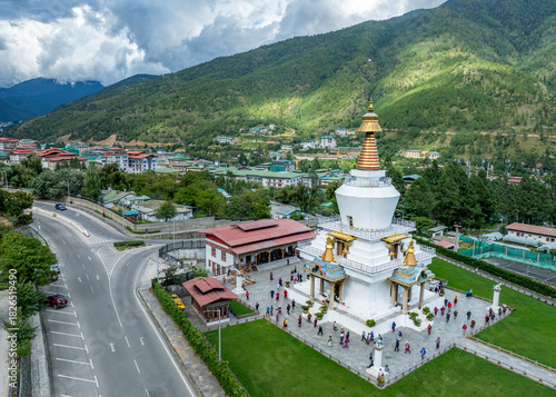 Aerial view of the gleaming white chorten with its golden spire stands majestically amidst green lawns and buildings, Doeboom Lam, Thimphu, Thimphu, Bhutan.