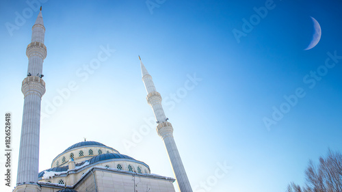 Ramadan or islamic background image. Haci Osman Efendi Mosque with crescent moon