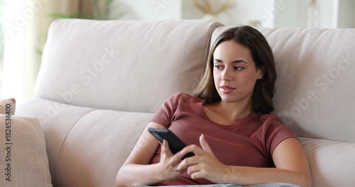 Happy woman talking on phone at home