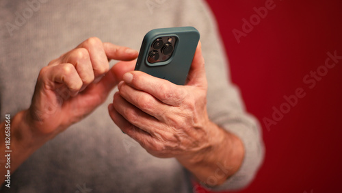 Closeup, man holding mobile phone text message, scrolling, watching video selective focus on hands
