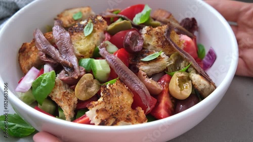 Italian panzanella with anchovies, olives and tomatoes.