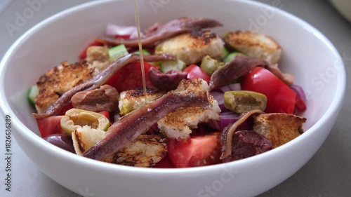 Italian panzanella with anchovies, olives and tomatoes.