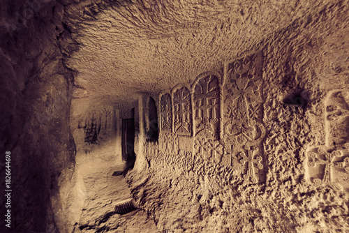 Entrance to the cave church with engraved crosses on the stone wall. Geghard Monastery, Goght, Kotayk Province, Armenia
