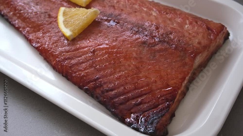 Christmas salmon cooking in pomegranate juice with orange and pomegranate seeds.
