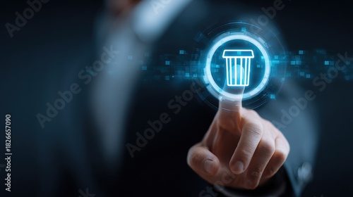 Businessman finger tapping illuminated delete trash bin icon on futuristic digital interface screen.