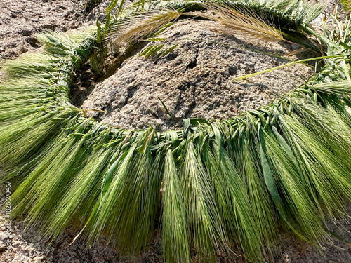 A hand-woven wreath of grass stalks
