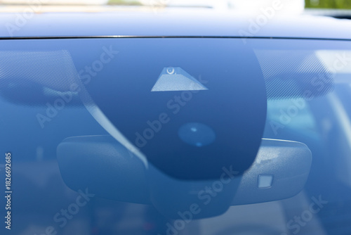 Rain and light sensor on the windshield of the car. Close up view of modern driver assistance. Car System Intelligence - Surround View 360 Degrees Bird Eye View, Line Assist, Front Camera