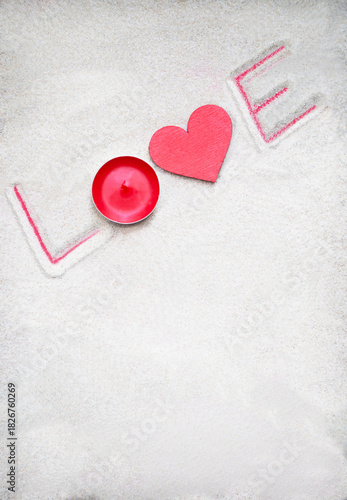 Word love made of stones, candle, letters drawing on the sand background. Valentine's day, mother's, woman's day, honeymoon, vacation, summer background. Empty place for message. Flat lay. Mockup.