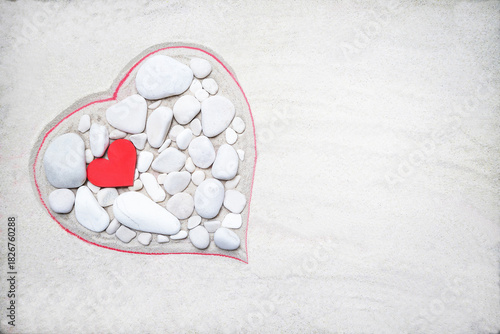 Heart made of white stones on a sand background. Wooden red heart is between stones. Valentine's Day, mother's, woman's day, honeymoon, vacation, summer background. Empty place. Flat lay. Mockup.