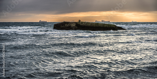 Fototapeta Naklejka Na Ścianę i Meble -  Sunset Over The Ocean With Distant Ships And Coastal Dunes On A Calm Horizon Today, Skagen, Denmark