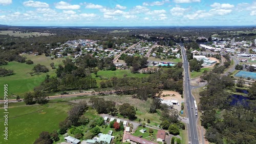 Aerial view of Mount Barker, Western Australia. Top down footage of small tourist country town in Australia. Town buildings and home can be seen with green pastures and forests. Main highway with cars