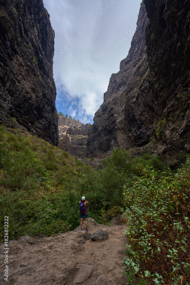 Fototapeta premium Hiker in dramatic narrow canyon