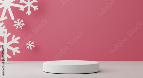 Minimalist white podium display against a vibrant pink wall decorated with falling white paper snowflakes for winter holiday product presentation
