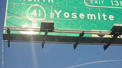 Highway sign for Yosemite exit 131 on Route 41 under a clear blue sky.