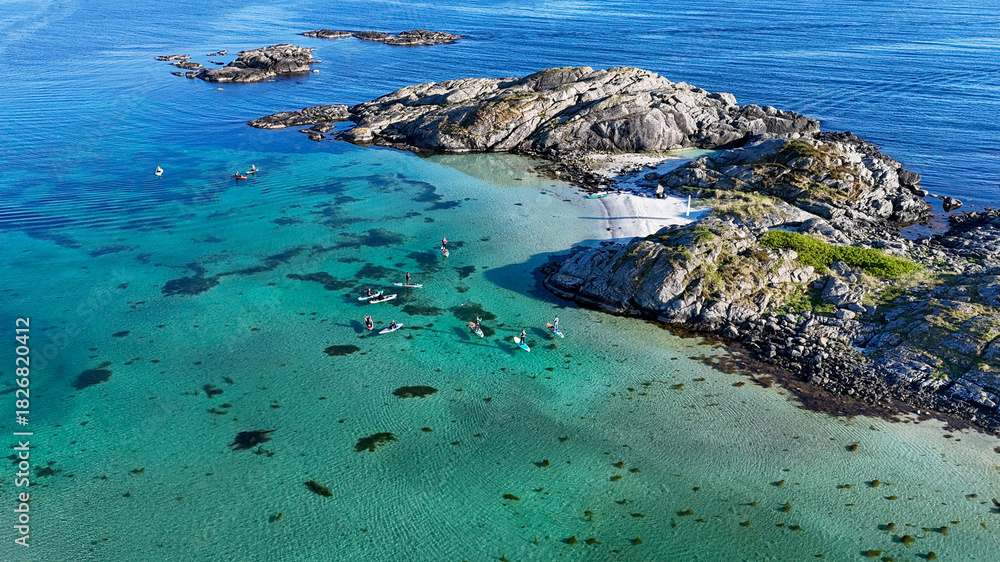Obraz premium Drone photo of paddleboarders on the Norwegian coast