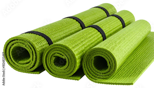 Several lime-green rolled mats are secured with black bands, set against a transparent backdrop
