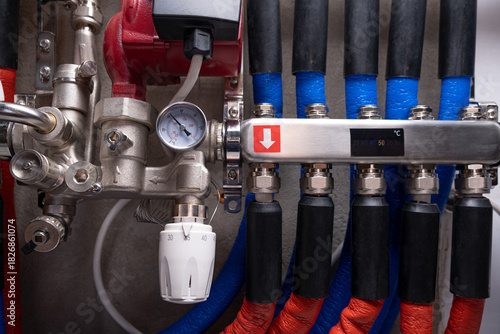 Complex residential heating manifold system with valves, gauges, and piping network