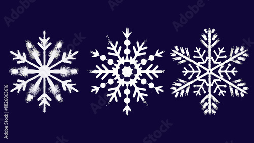 Three white snowflakes with a textured appearance on a dark blue background