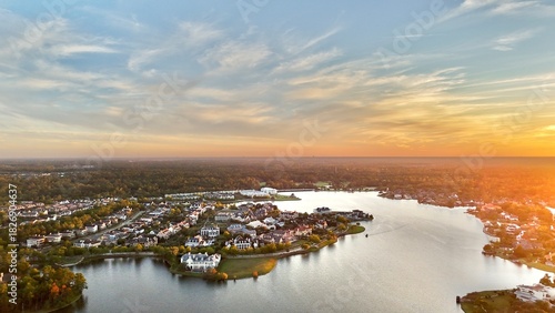 Aerial view of large mansion houses with swimming pool,  in affluent neighborhood  by Woodlands lake, Houston, Texas, expensive suburban homes surrounding by lush green trees at sunset, USA 