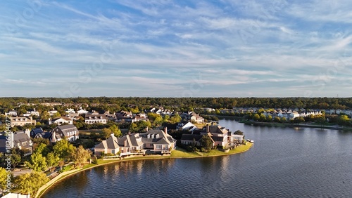 Aerial view of large mansion houses with swimming pool,  in affluent neighborhood  by Woodlands lake, Houston, Texas, expensive suburban homes surrounding by lush green trees, USA