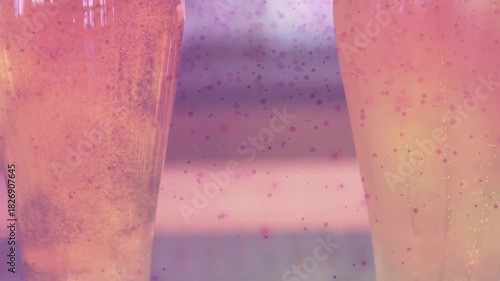 Speckled overlay appearing, camera revealing two pint glasses filling, foaming, showing carbonation