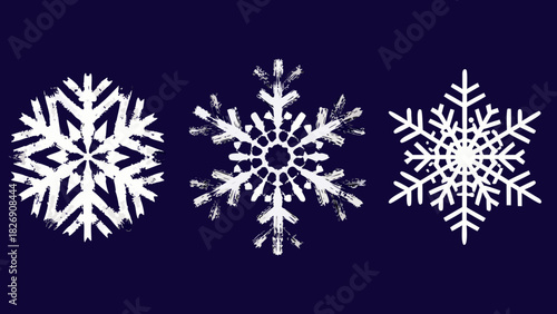 Three white snowflakes with textured edges on dark blue background