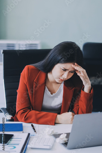 tired business woman sleepy and bored from sitting at a desk for a long time and has office syndrome