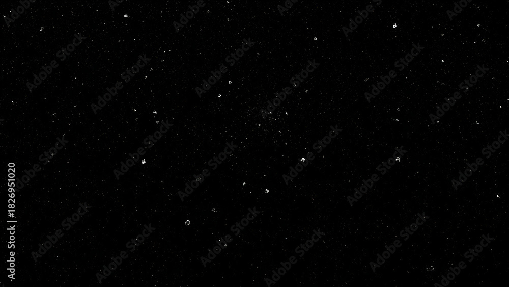 Obraz premium Black background with scattered white dust particles